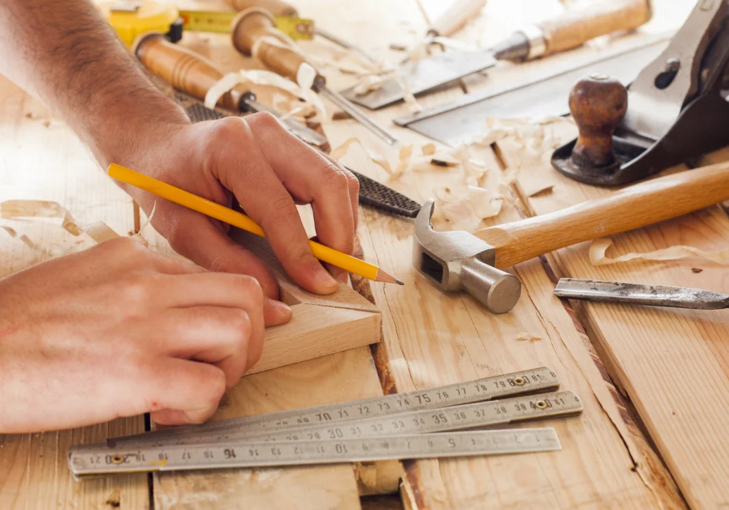 Artisan crafting wooden chair in workshop