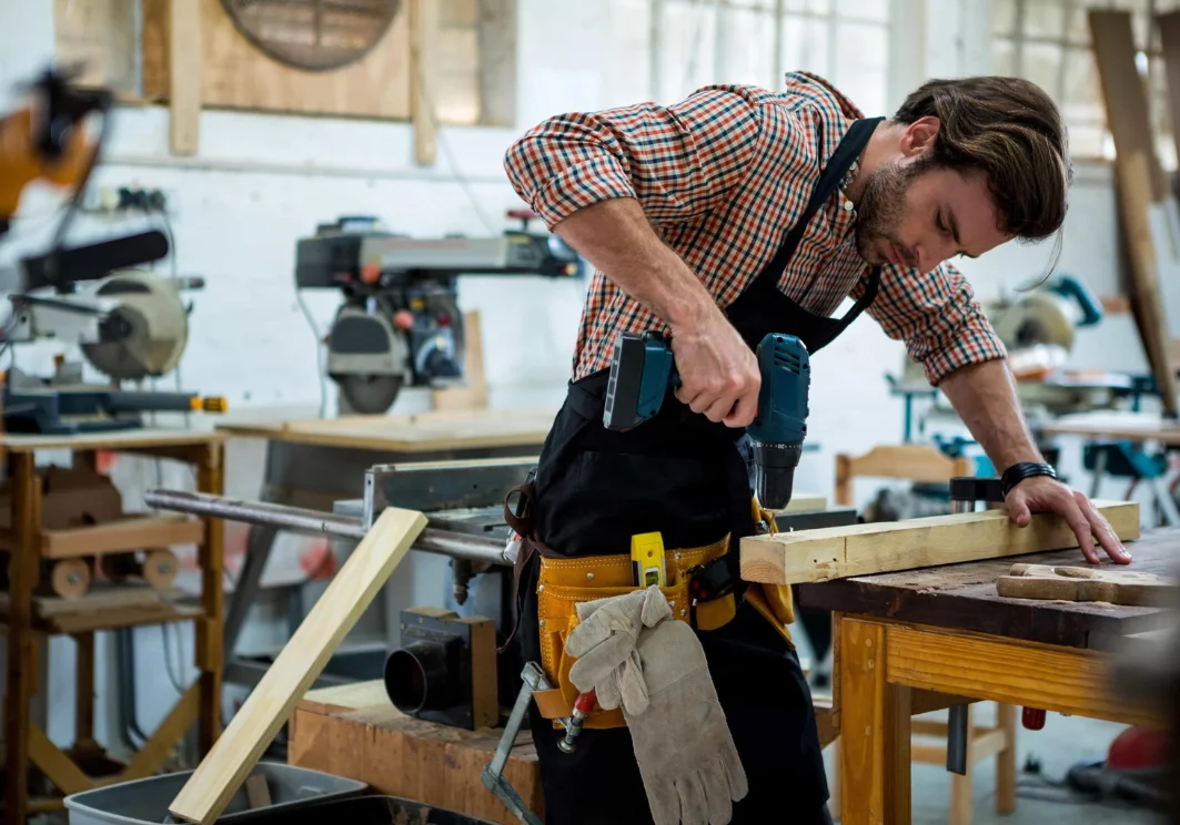 Carpenter crafting wooden furniture in workshop